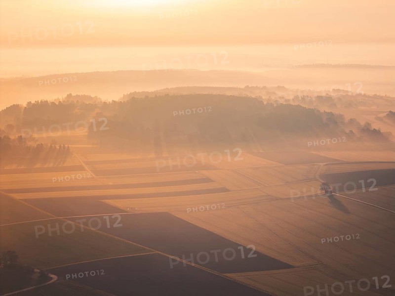 Wide, misty landscape with softly lit hills and fields at sunrise, Gechingen, Calw district, Germany