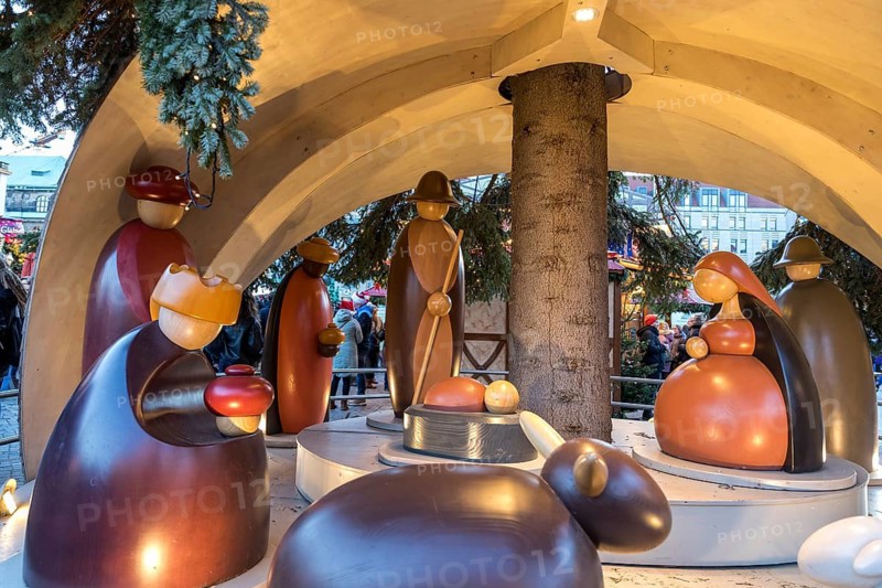 Large wooden crib figures in the middle of the Striezelmarkt Christmas market, Dresden, Saxony, Germany