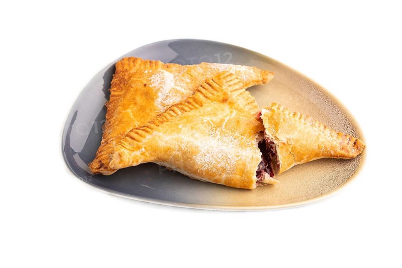 Triangles Pie, Puff Pastry, Samsa with cherry jam isolated on white background, side view, close up
