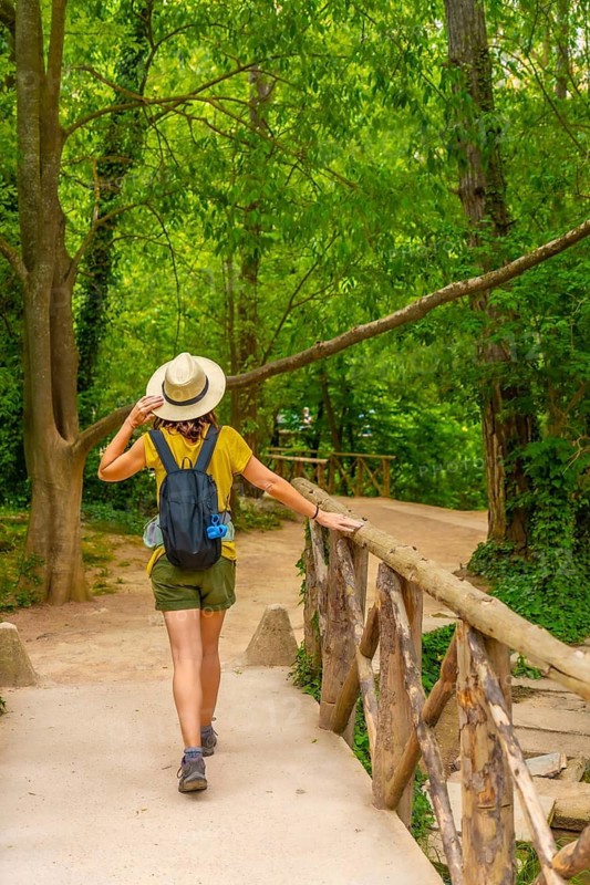 A tourist with a hat enjoying a walk in the Natural Park of the Monasterio de Piedra, Aragon