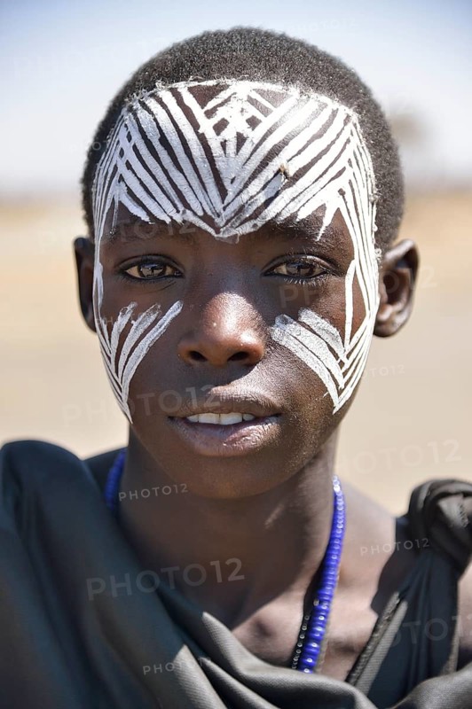 Young Maasai warrior with a painted face, Ngorongoro Conservation Area, Ndema, Tanzania