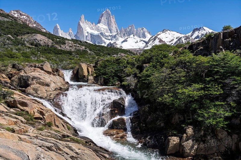 Chorrillo del Salto waterfall amidst rocky landscape with views of snow-capped Cerro Fitz Roy, Los Glaciares National Park, El Chaltén, Santa Cruz Province, Argentina