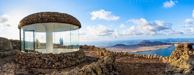 Stairway and viewing platform at the Mirador del Río viewpoint, in the evening light with sun stars, designed by artist César Manrique, view of the island of La Graciosa, Lanzarote, Canary Islands, Spain
