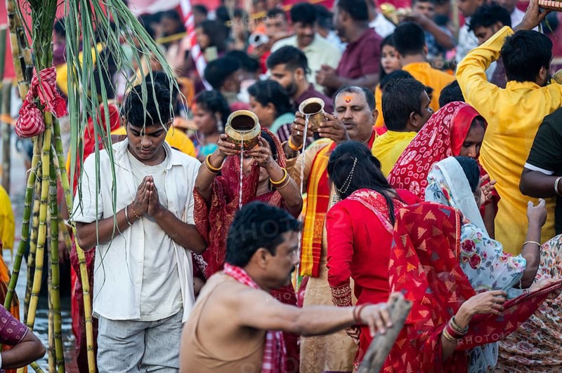 Hindu devotees gather on the banks of the Brahmaputra River to offer prayers to the Sun God on the occasion of Chhath Puja, in Guwahati, India on 27 October 2025