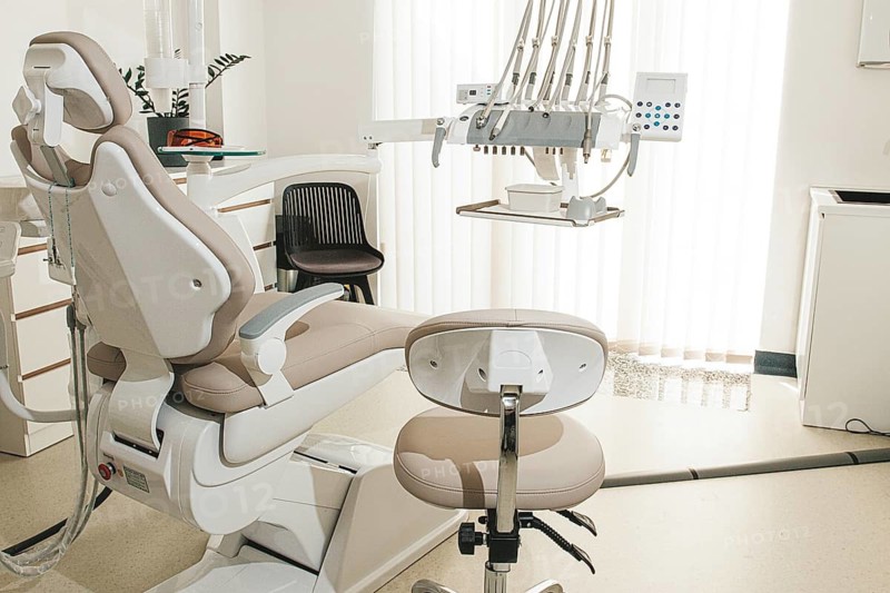 Modern dental clinic interior with equipment and patient chair ready for treatment