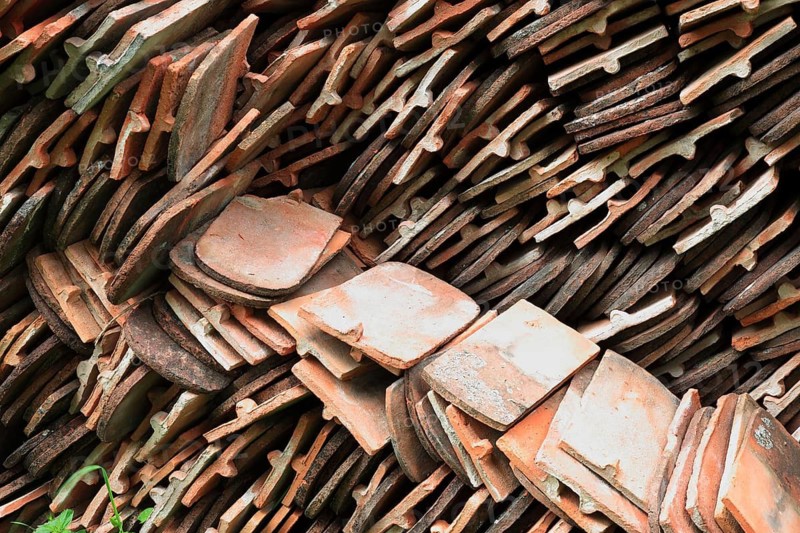 Old roof tiles stored on stockpiles for reuse on historic buildings and heritage-protected houses, beaver tail tiles, clay tiles