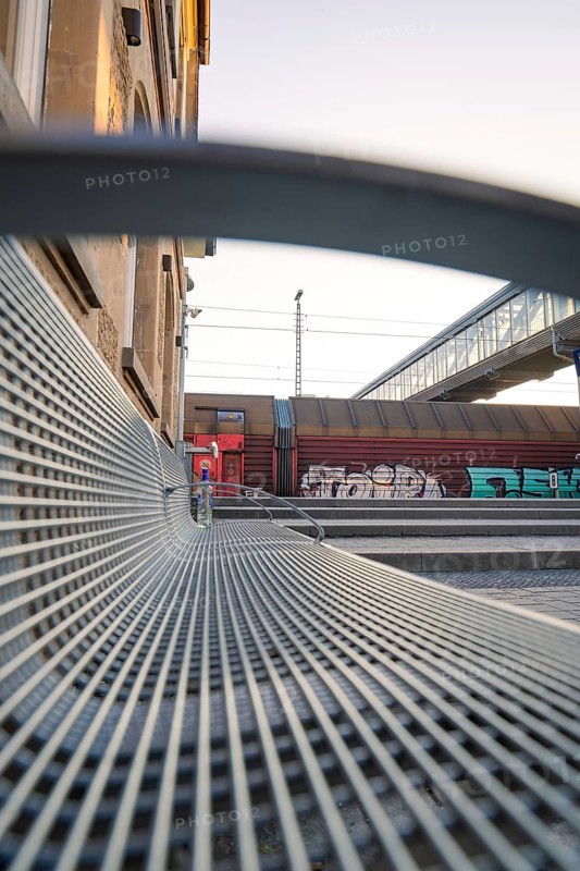 A metal bench at the railway station, accompanied by modern architecture and colourful graffiti art, Sindelfingen railway station, Böblingen district, Germany
