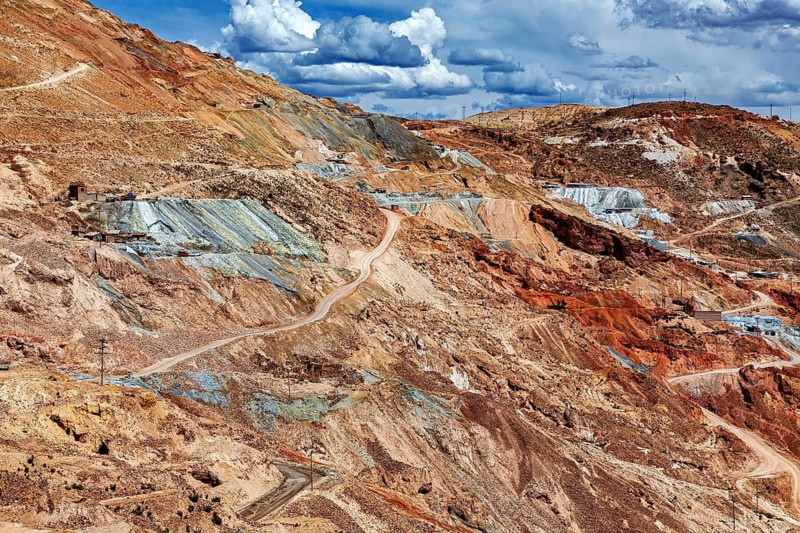 Extensive mining landscape with bare, colorful rocks under cloudy sky, The silver mines of Potosi on Cerro Rico in Bolivia