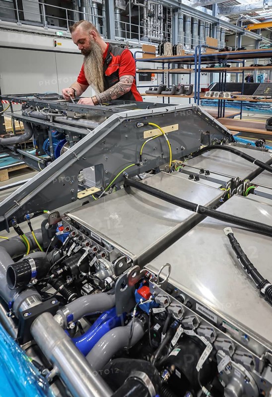 Herten, North Rhine-Westphalia, Germany, Cummins Hydrogenics fuel cell factory. An employee assembles fuel cell systems for Alstom's Coradia iLint hydrogen trains. The Coradia iLint is the world's first passenger train to be powered by a hydrogen fuel cell, which generates electrical energy for propulsion. Six fuel cell modules are installed in each train (right in the picture) . Note: The person pictured has given their verbal consent for publication in the press