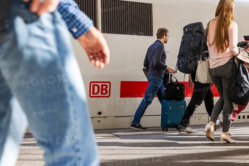 Stuttgart Central Station. Travelers on the platform. ICE with Deutsche Bahn AG logo. Stuttgart, Baden-Württemberg, Germany