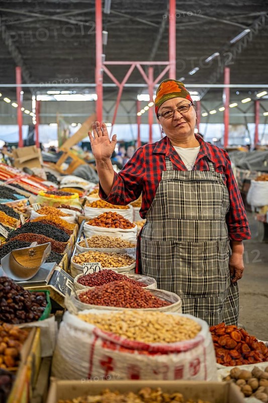 Traditional woman selling food, market stall at Osh Bazaar, Bishkek, Kyrgyzstan