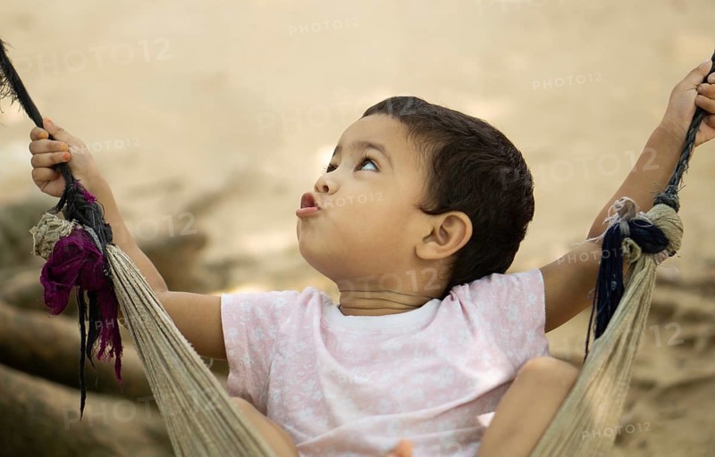 Gazipur, Bangladesh- 22 June 2025: A close up of a child playing on a swing