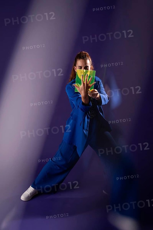 A young woman interacts with a futuristic device, integrating technology and innovation. Her focus and the modern design highlight the seamless blend of humans and digital interfaces
