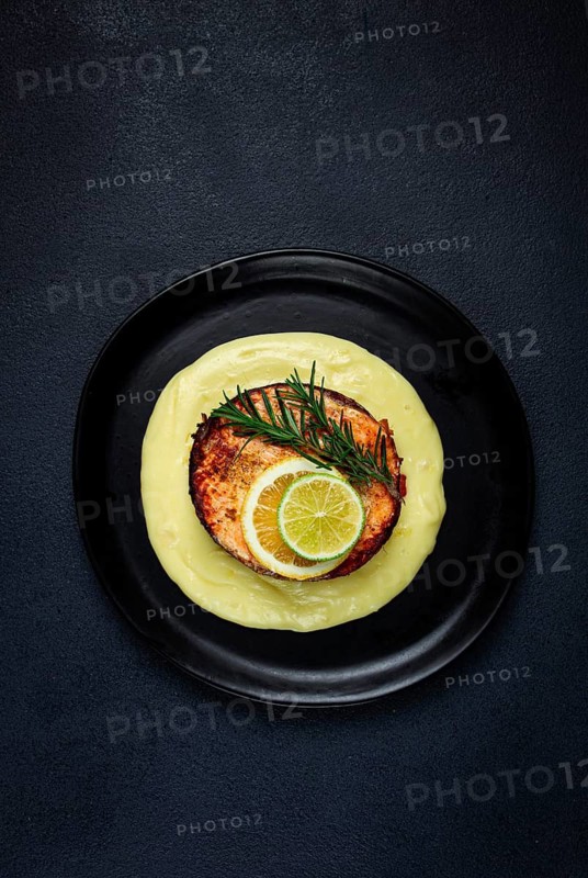 Salmon steak, fried, mashed potatoes, top view, rosemary, lemon and lime, homemade, one serving, no people