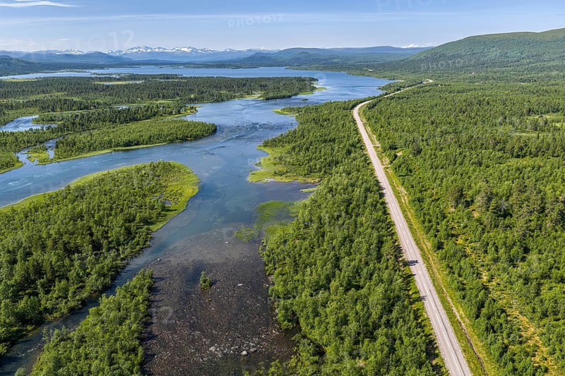 Road along lakes and green forest, road Kiruna to Nikkaluokta, aerial view, Sweden