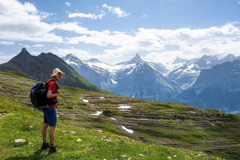 Hikers in front of picturesque mountain landscape, Schreckhorn and Finsteraarhorn peaks, Bernese Alps, Bernese Oberland, Switzerland