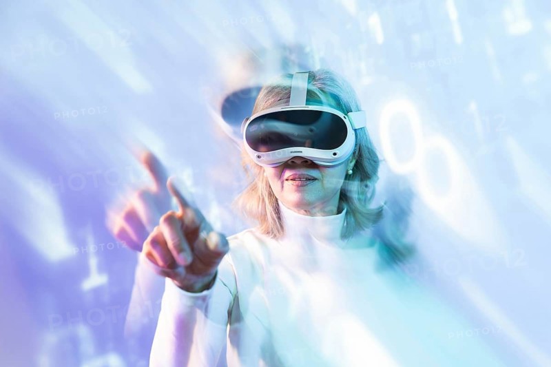 Elderly Asian woman immersed in the metaverse, exploring virtual environments with a VR headset. The blue and purple hues create a futuristic and immersive atmosphere