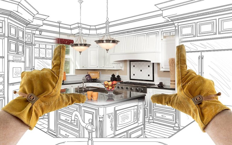Male Contractor Hands Framing Completed Section of Custom Kitchen Design Drawing
