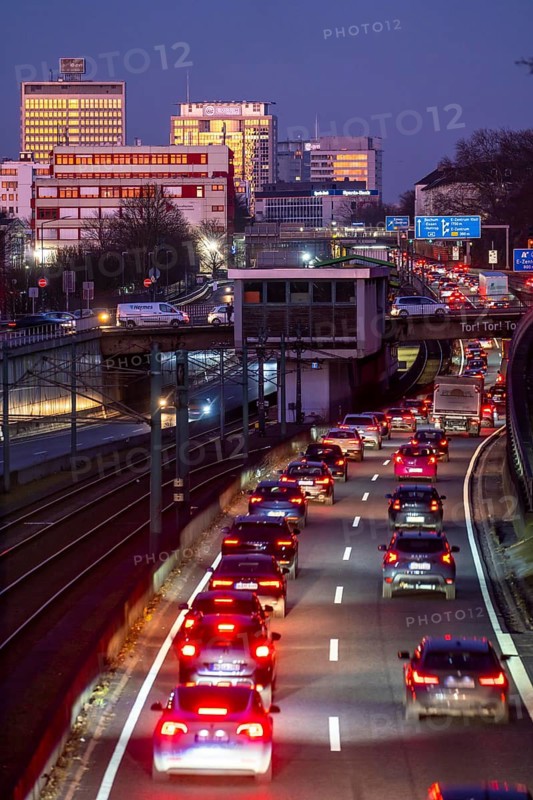 Motorway A40, Ruhr expressway, heavy traffic jam, rush hour, city passage in Essen, skyline of the city centre, underground line between the lanes, Hobeisenbrücke stop, North Rhine-Westphalia, Germany
