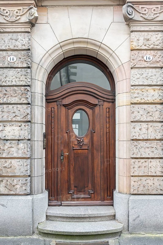 Stylish wooden door, arched door with oval window in a decorative frame in the historic old town of Constance, traditional craftsmanship, district of Constance, Baden-Württemberg, Germany