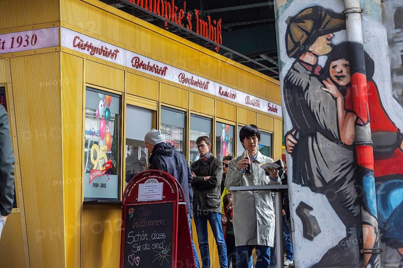Cult in Berlin: Currywurst at Konnopke's Imbiss. Kiosk with neon sign and logo. Berlin, Germany