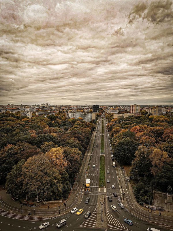 A sepia view of Berliner Straße in autumn with dramatic sky conveying a nostalgic atmosphere, view from Victory Column, Berlin
