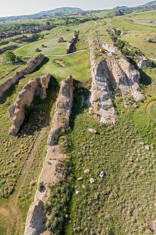 Golden, Colorado, Footprints of dinosaurs and traces of other animals and plants from the Late Cretaceous period are found along the Triceratops Trail in this former clay mine. The fossils were revealed on the hard sandstone fins after clay was removed between them. Visitors can explore the fossils or play golf at the Fossil Trace Golf Club. A dragline from the mining days remains atop one of the sandstone fins