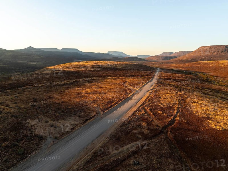 Aerial view, road leading through dry desert landscape, hills in Damaraland, Namibia