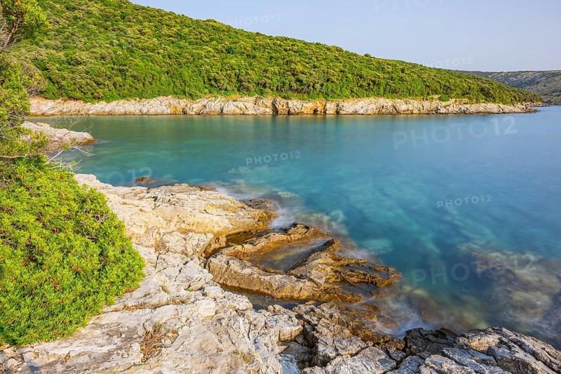 Crystal clear and turquoise water on the beach of Ustrine Bay on a sunny day on the island of Cres, long exposure, Croatia