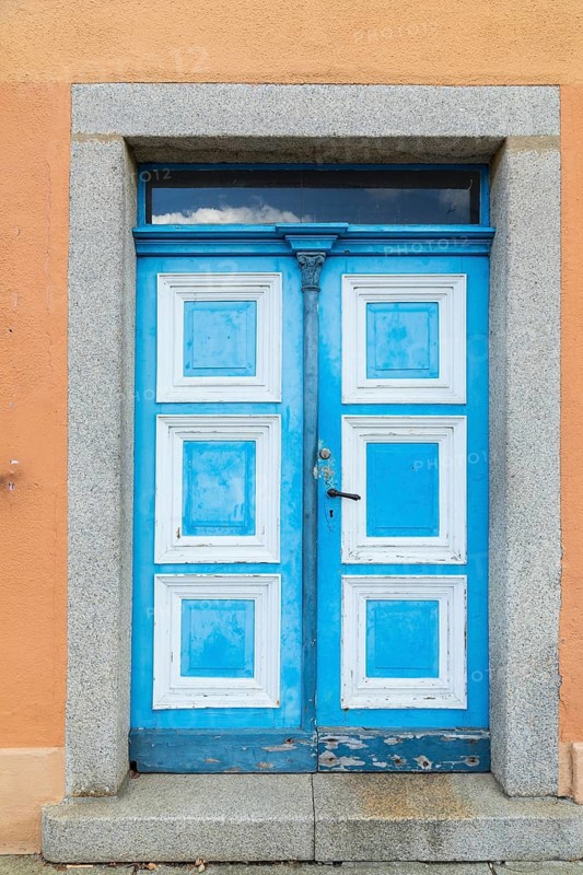 Historic wooden door in blue and white on the market square in Weißenberg, Saxony, Germany