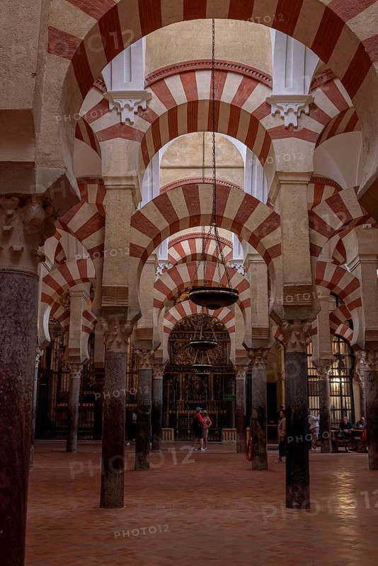 Arches and columns in a spacious interior with dominant red and white colours, Cathedral Mosque of Córdoba (Mezquita-Catedral), Cordoba, Andalusia, Spain