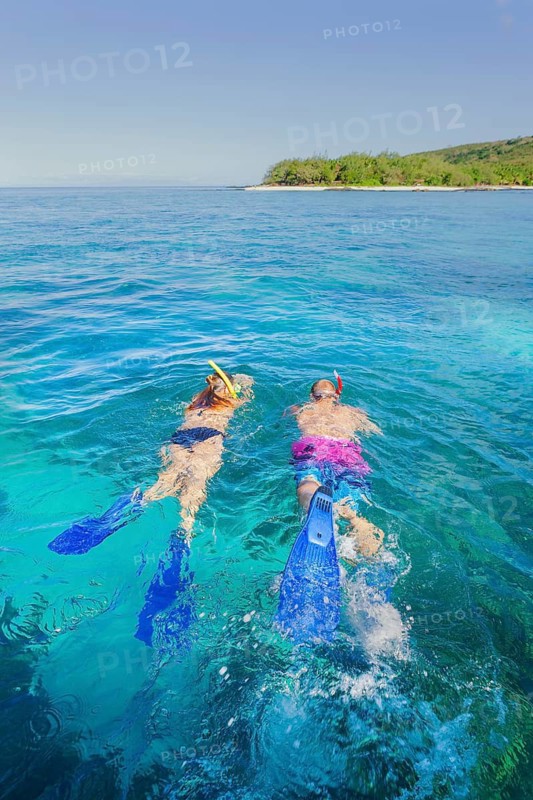 Couple snorkelling in Fiji Islands clear water, Drawaqa Island, Yasawa island group, Fiji