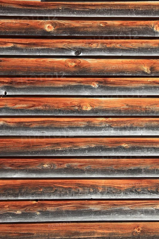 Facade cladding with wood, boards, partly already weathered