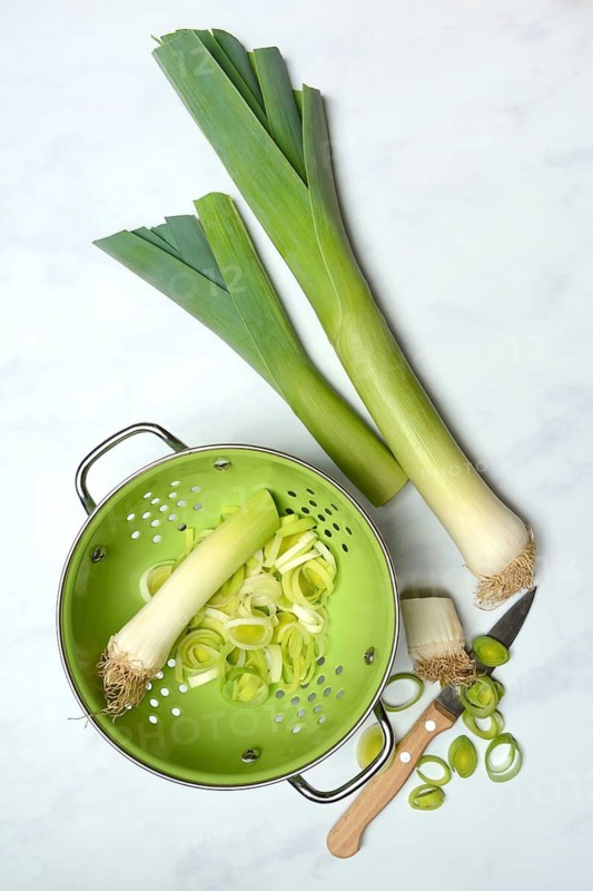Leek, leek sticks and leek rings in a sieve bowl