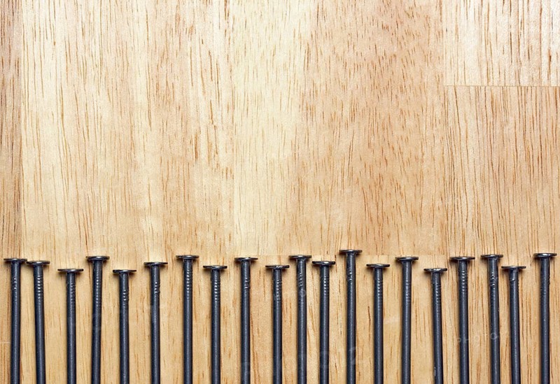Macro of Nails on a Wood Background
