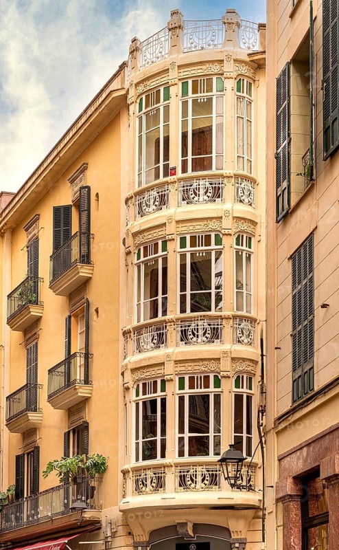 Historic and decorative house façade of a tenement house in Carrer de Constitució, Palam de Majorca, Spain