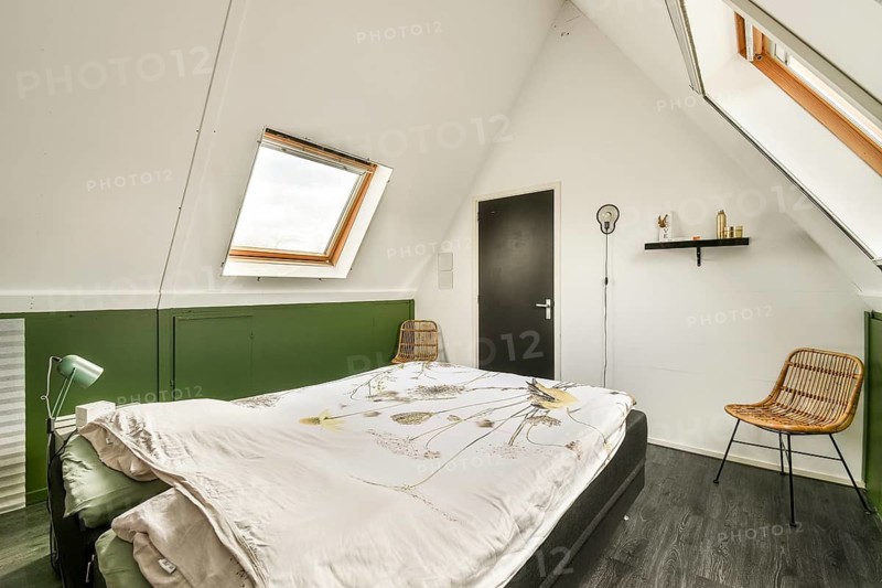 A stylish modern bedroom featuring natural light, minimalist decor, and a calming color palette that enhances relaxation and comfort