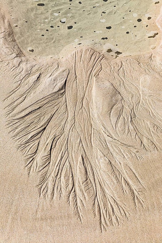 Seawater run-off leaves traces in the sand on Fazayat beach in Al Hauta, Dhofar province, Arabian Peninsula, Sultanate of Oman