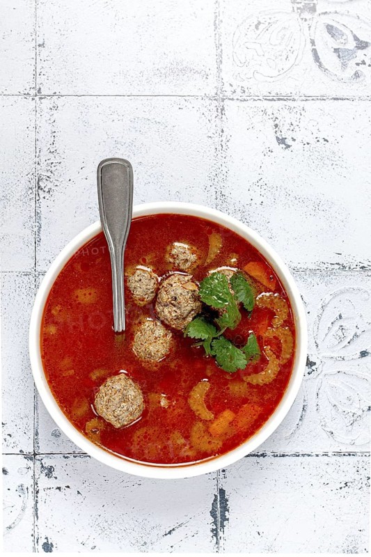 Romanian soup with meatballs, vegetable soup with meatballs, tiled table, homemade, no people