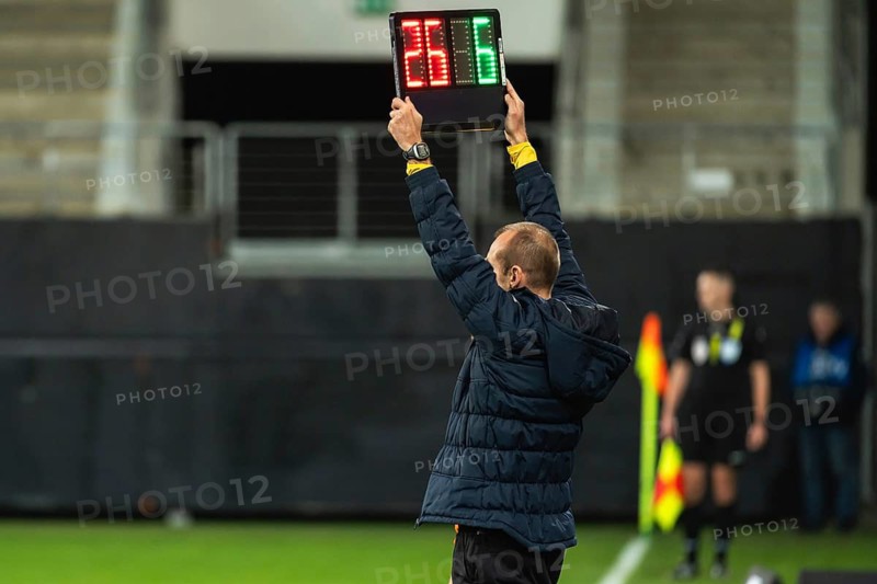 Team manager man shows players substitution during football match in Lubin, Poland