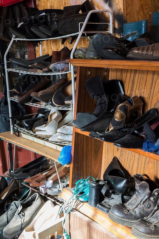 Racks with old men's and woman's shoes for sale inside second hand goods and chattels store, Quebec, Canada