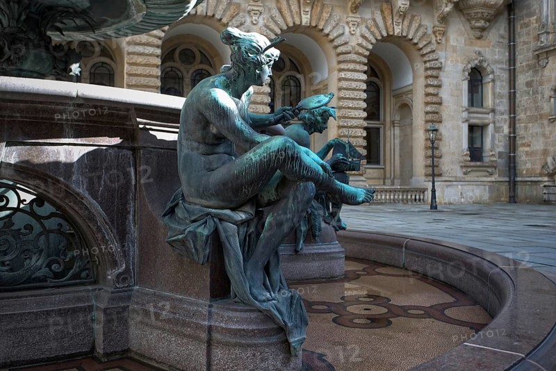 Partial view of the Hygieia fountain with an artistic sculpture in the courtyard of Hamburg City Hall, Hamburg, Germany