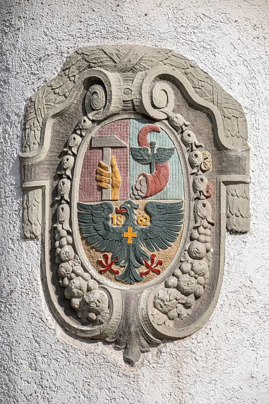 Historical coat of arms carved out of stone, stonemasonry on the façade of the Count's House in the old town of Rottweil with imperial eagle, hammer and cornucopia as a symbol and reference to the use of this historic building, Rottweil district, Baden-Württemberg, Germany