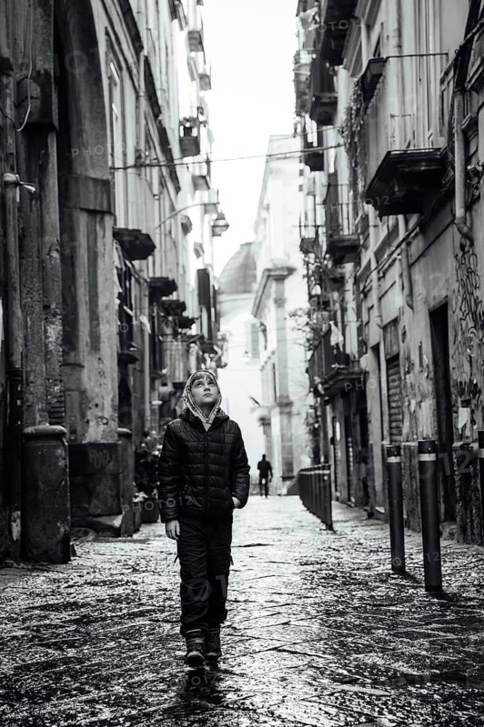 Young boy in a narrow street of Naples, Italy
