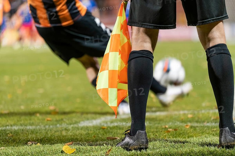 Footballer takes the corner. Detail of referee's legs during soccer match in Glogow, Poland