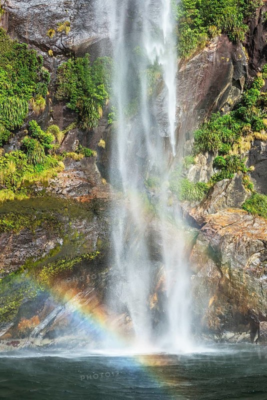 Rainbow over waterfall, Milford Sound, Fiordland National Park, South Island, Southland, New Zealand