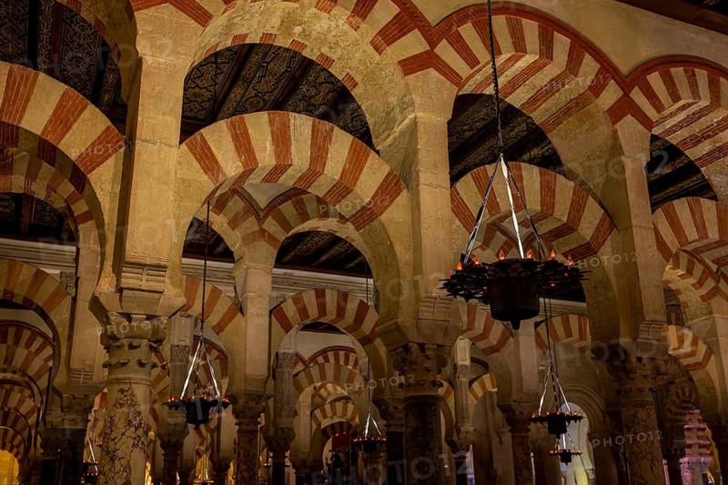 MKathedral Mosque of Córdoba (Mezquita-Catedral), auric arches of the mosque with richly decorated lamps and characteristic red and white colouring, Cordoba, Andalusia, Spain
