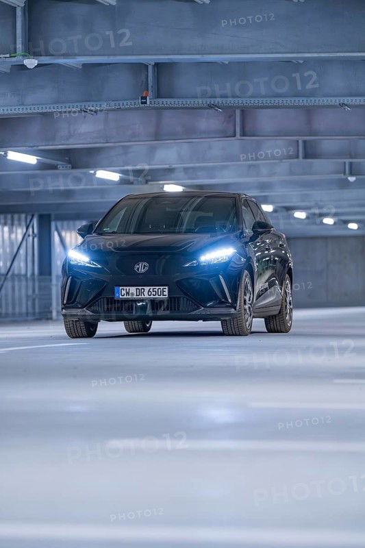 Black car with blue front lights in a multi-storey car park, e-car sharing, Deer Mobility, MG4, Calw, Germany