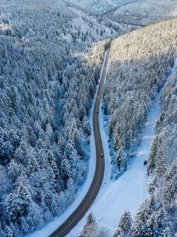 Bird's eye view of a snow-covered road winding through a wintry forest, Bad Wildbad, district of Calw, Black Forest, Germany