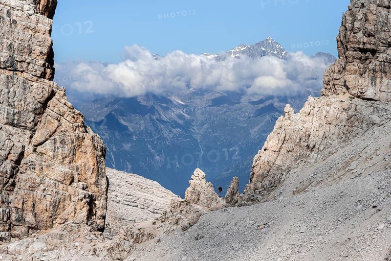 View through a flock of Cima Presanella, hikers on the Via Ferrate Benini via ferrata, Brenta Mountains, Brenta-Adamello Natural Park, Trentino, Italy